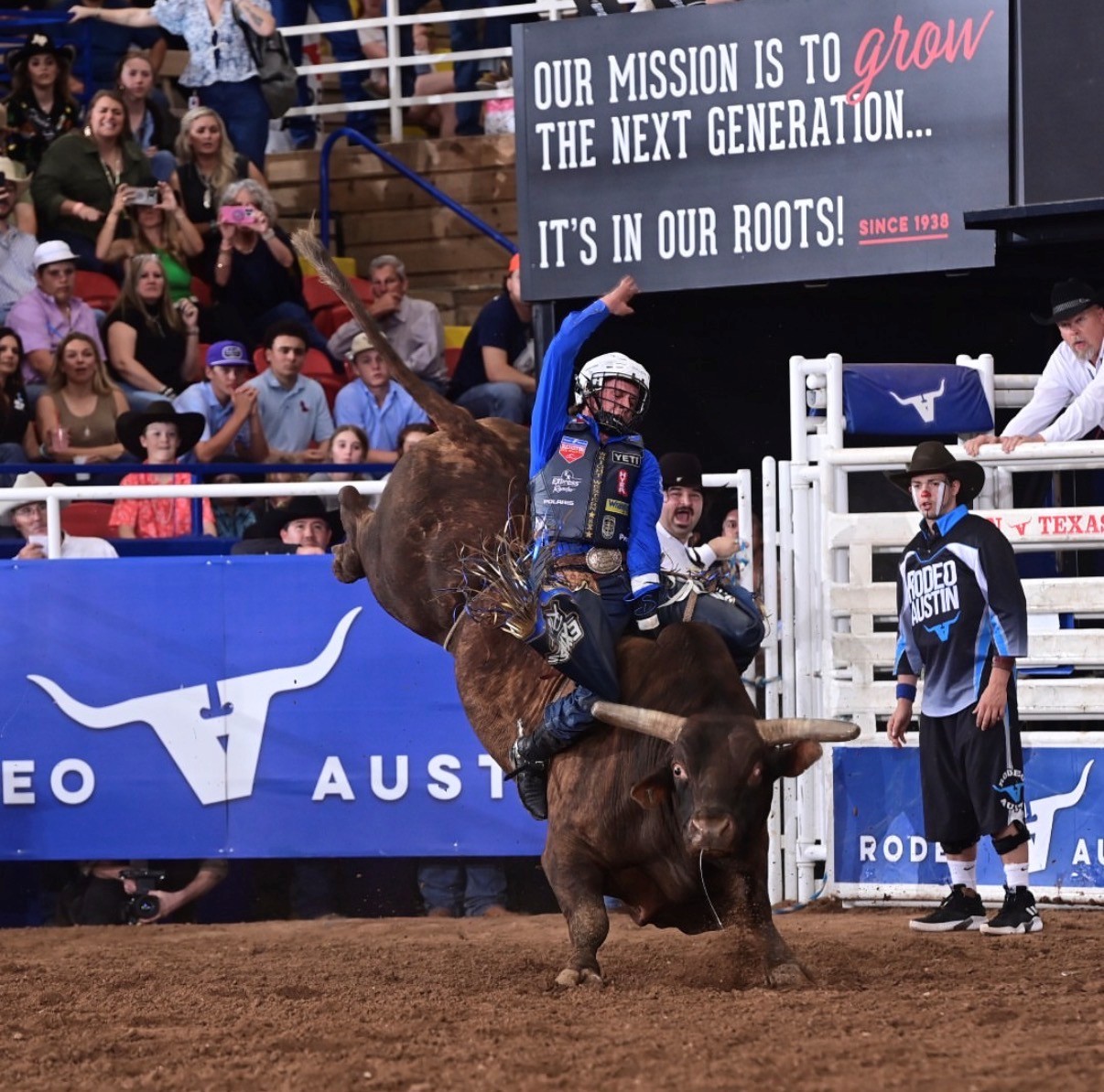 Bull rider competing at Rodeo Austin, a community event supported by Skinner Transportation